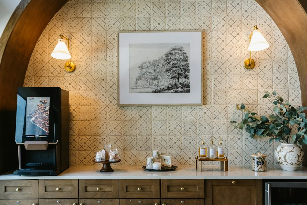 A coffee counter with a brewer, cups, and preparation space